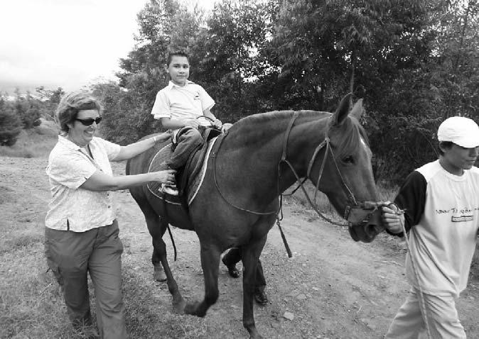 Hippotherapy (horseback therapy) involves the child sitting astride the horse outfitted with saddle and reins, while the therapist walks alongside to give whatever assistance the child needs to stay balanced in the saddle.
